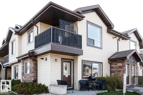 Back of property featuring a balcony, stone siding, and a patio area - 86 604 62 Street, Edmonton, AB - Outdoor
