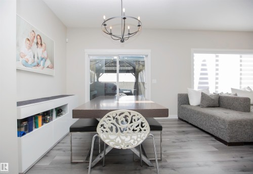 Dining space with suspended lighting and dark wood-style floors - 15 Springbrook Wynd, Spruce Grove, AB - Indoor