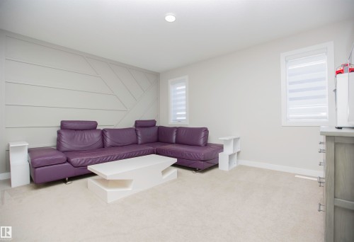 Living room with light carpet, an accent wall, and a decorative wall - 15 Springbrook Wynd, Spruce Grove, AB - Indoor Photo Showing Living Room