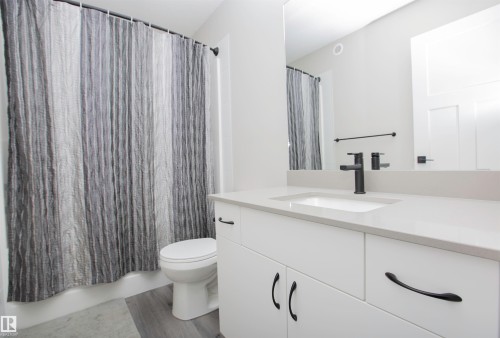 Full bath featuring vanity and dark wood-style flooring - 15 Springbrook Wynd, Spruce Grove, AB - Indoor Photo Showing Bathroom