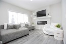 Living room featuring a glass covered fireplace and light wood finished floors - 15 Springbrook Wynd, Spruce Grove, AB  - Indoor Photo Showing Living Room With Fireplace 