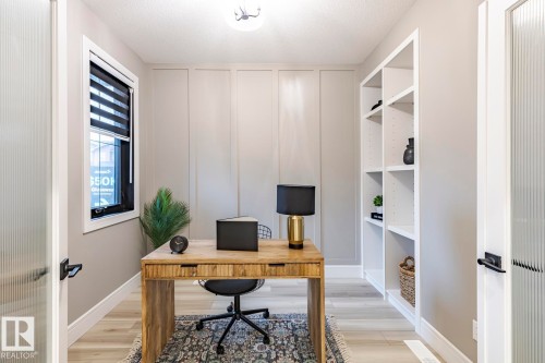 Office space featuring light wood-type flooring and a decorative wall - 6275 180 Avenue, Edmonton, AB - Indoor Photo Showing Office