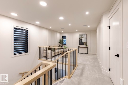 Hall featuring an upstairs landing, a decorative wall, recessed lighting, and light colored carpet - 6275 180 Avenue, Edmonton, AB - Indoor Photo Showing Other Room