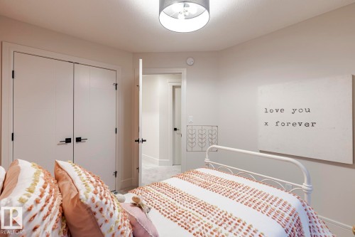 Bedroom with a closet and light carpet - 6275 180 Avenue, Edmonton, AB - Indoor Photo Showing Bedroom