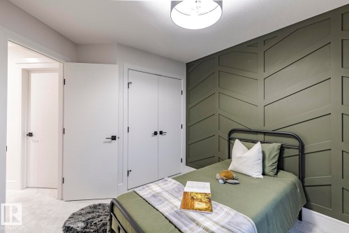 Bedroom with light colored carpet and a closet - 6275 180 Avenue, Edmonton, AB - Indoor Photo Showing Bedroom