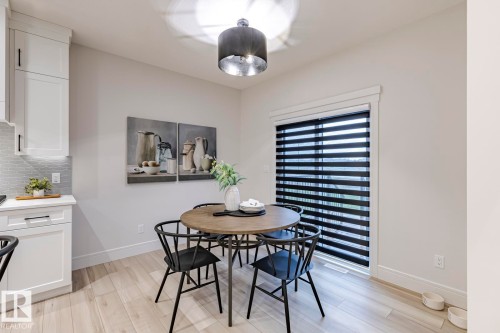 Dining area featuring light wood-style flooring and baseboards - 6275 180 Avenue, Edmonton, AB - Indoor Photo Showing Dining Room