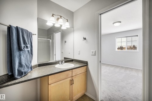 Full bath featuring vanity, light colored carpet, and a stall shower - 3401 47 Street, Beaumont, AB - Indoor Photo Showing Bathroom