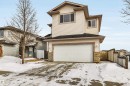 Traditional home with an attached garage, a gate, brick siding, and roof with shingles - 3401 47 Street, Beaumont, AB  - Outdoor 