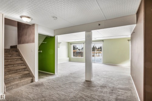 Below grade area featuring light carpet and wainscoting - 3401 47 Street, Beaumont, AB - Indoor Photo Showing Other Room
