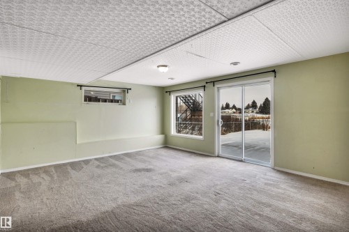 Unfurnished room with light colored carpet - 3401 47 Street, Beaumont, AB - Indoor Photo Showing Other Room