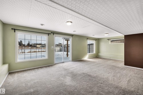 Unfurnished room with carpet floors and baseboards - 3401 47 Street, Beaumont, AB - Indoor Photo Showing Other Room