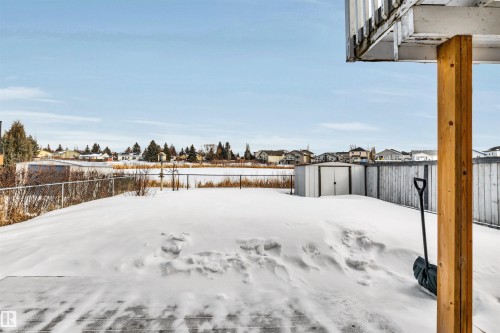 Fenced backyard with a residential view and a storage unit - 3401 47 Street, Beaumont, AB - Outdoor