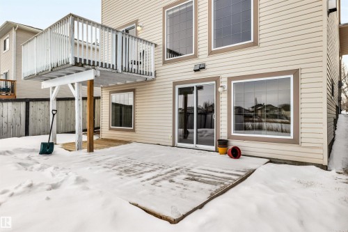 Snow covered back of property with a balcony and a patio area - 3401 47 Street, Beaumont, AB - Outdoor With Exterior