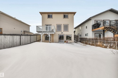 Snow covered rear of property with a fenced backyard and a balcony - 3401 47 Street, Beaumont, AB - Outdoor With Exterior
