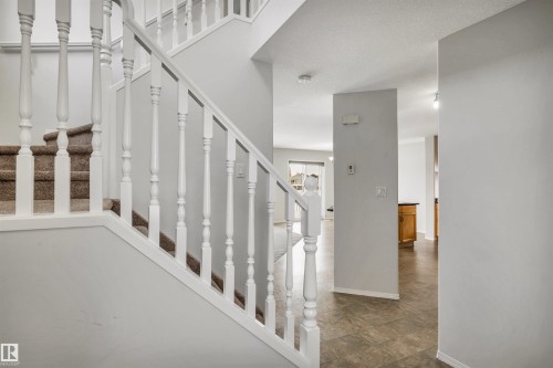 Staircase with baseboards - 3401 47 Street, Beaumont, AB - Indoor Photo Showing Other Room