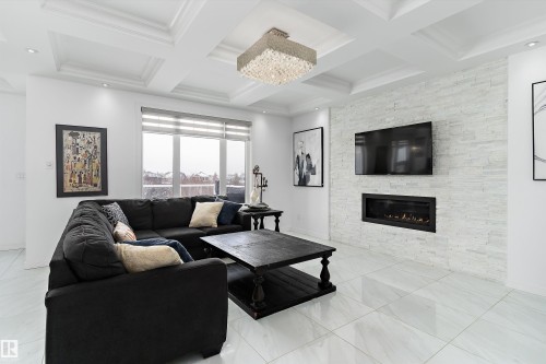 Living room featuring a fireplace and coffered ceiling - 1242 Starling Drive, Edmonton, AB - Indoor Photo Showing Living Room With Fireplace