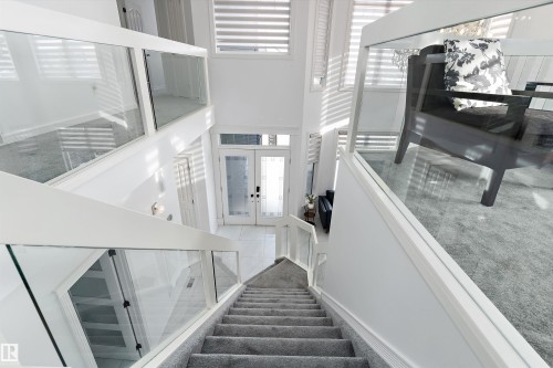 Stairway with a high ceiling and french doors - 1242 Starling Drive, Edmonton, AB - Indoor Photo Showing Other Room