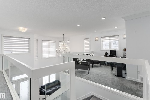 Home office featuring carpet flooring, a chandelier, a textured ceiling, and ornamental molding - 1242 Starling Drive, Edmonton, AB - Indoor