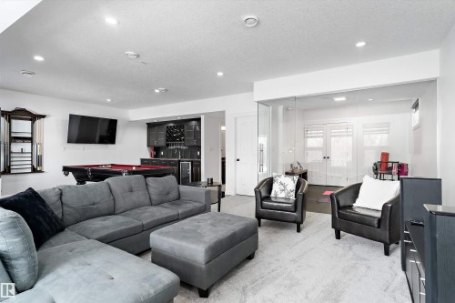 Living area featuring bar with sink, billiards, a textured ceiling, and recessed lighting - 1242 Starling Drive, Edmonton, AB - Indoor Photo Showing Living Room