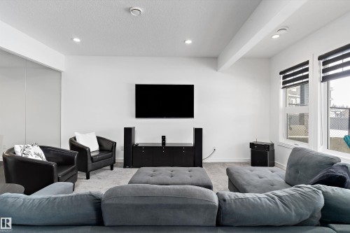 Carpeted living room featuring recessed lighting and a textured ceiling - 1242 Starling Drive, Edmonton, AB - Indoor Photo Showing Living Room