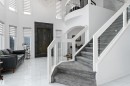 Stairway with healthy amount of natural light, a high ceiling, and marble finish flooring - 1242 Starling Drive, Edmonton, AB  - Indoor Photo Showing Other Room 