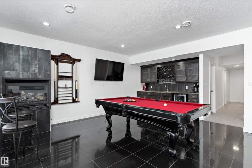 Recreation room featuring bar with sink, billiards table, beverage cooler, a textured ceiling, and recessed lighting - 1242 Starling Drive, Edmonton, AB - Indoor Photo Showing Other Room