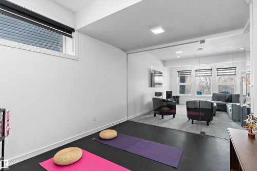 Exercise area featuring a textured ceiling and baseboards - 1242 Starling Drive, Edmonton, AB - Indoor