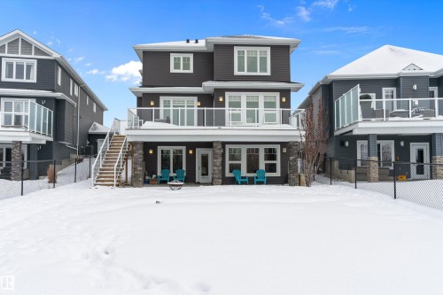 Snow covered property with stone siding and french doors - 1242 Starling Drive, Edmonton, AB - Outdoor With Facade