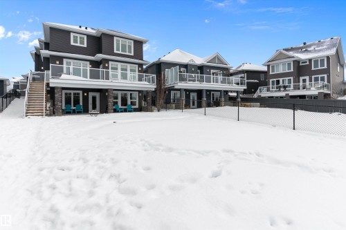 Snow covered house featuring stairway and stone siding - 1242 Starling Drive, Edmonton, AB - Outdoor With Facade