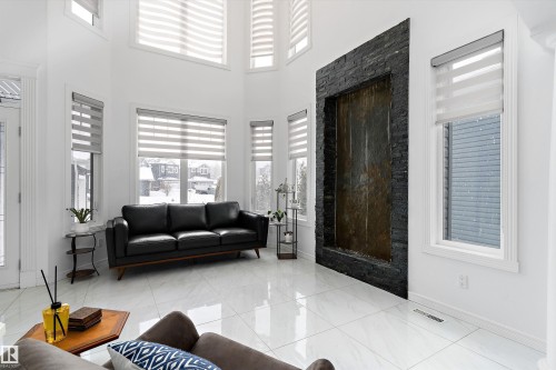 Living area with a high ceiling and baseboards - 1242 Starling Drive, Edmonton, AB - Indoor Photo Showing Living Room With Fireplace