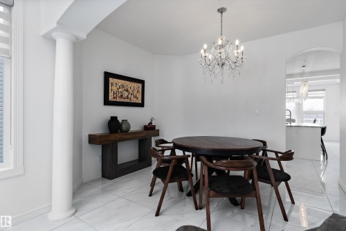 Dining space featuring ornate columns, a chandelier, and arched walkways - 1242 Starling Drive, Edmonton, AB - Indoor Photo Showing Dining Room
