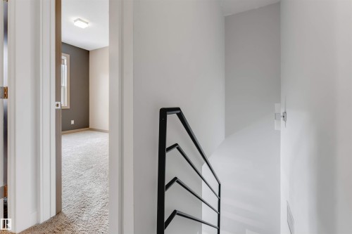 Hall with an upstairs landing and light colored carpet - 102 10711 83 Avenue, Edmonton, AB - Indoor Photo Showing Other Room