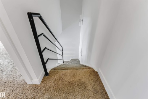 Stairway featuring carpet flooring and baseboards - 102 10711 83 Avenue, Edmonton, AB - Indoor Photo Showing Other Room