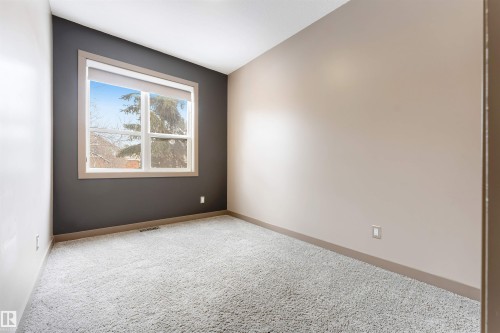 Unfurnished room with light colored carpet and baseboards - 102 10711 83 Avenue, Edmonton, AB - Indoor Photo Showing Other Room