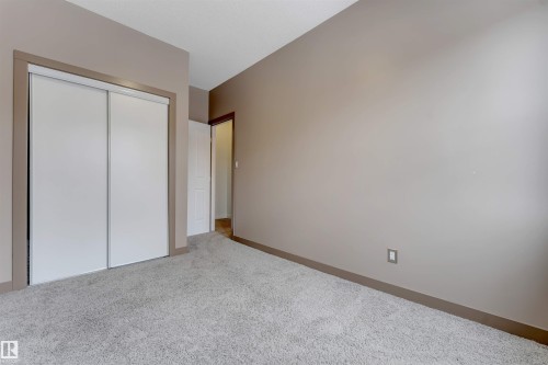 Unfurnished bedroom featuring light colored carpet and a closet - 102 10711 83 Avenue, Edmonton, AB - Indoor Photo Showing Other Room