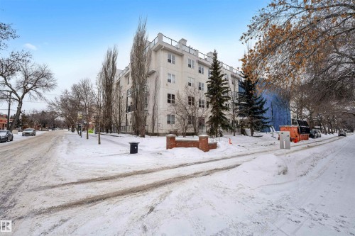 Snow covered property featuring a view of apartment building / complex - 102 10711 83 Avenue, Edmonton, AB - Outdoor