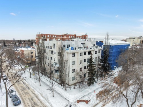Snow covered building featuring a view of apartment building / complex - 102 10711 83 Avenue, Edmonton, AB - Outdoor With View