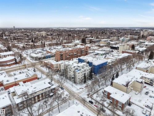 Snowy aerial view featuring a view of city - 102 10711 83 Avenue, Edmonton, AB - Outdoor With View