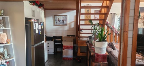 Interior space with wood walls, wood ceiling, and dark wood finished floors - 5216 - 53 Avenue, Clyde, AB - Indoor Photo Showing Other Room