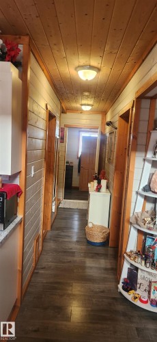 Hallway with wood ceiling, wooden walls, and dark wood-style flooring - 5216 - 53 Avenue, Clyde, AB - Indoor Photo Showing Other Room