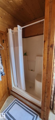 Full bath with wood ceiling, a shower stall, and tile patterned flooring - 5216 - 53 Avenue, Clyde, AB - Indoor Photo Showing Bathroom