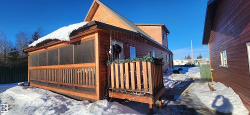Snow covered property featuring a sunroom - 5216 - 53 Avenue, Clyde, AB - Outdoor With Exterior