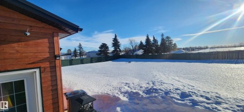 Snowy yard with a fenced backyard - 5216 - 53 Avenue, Clyde, AB - Outdoor