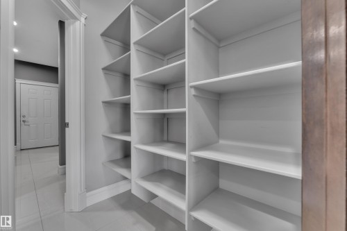 Walk in closet with light tile patterned flooring - 2612 Adam Court Sw, Edmonton, AB - Indoor With Storage