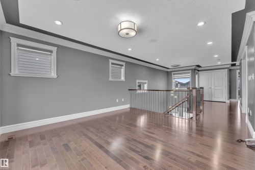 Unfurnished room featuring ornamental molding, recessed lighting, and dark wood-style floors - 2612 Adam Court Sw, Edmonton, AB - Indoor Photo Showing Other Room