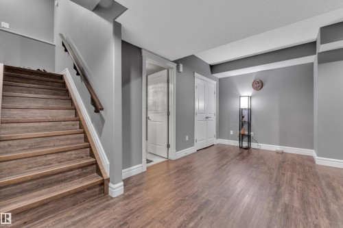 Basement with stairway and dark wood-style flooring - 2612 Adam Court Sw, Edmonton, AB - Indoor Photo Showing Other Room