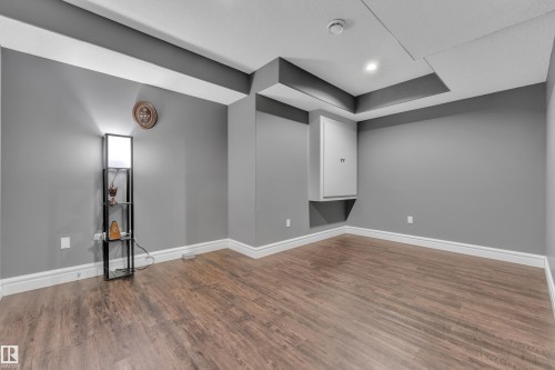Below grade area with dark wood-style flooring and recessed lighting - 2612 Adam Court Sw, Edmonton, AB - Indoor Photo Showing Other Room