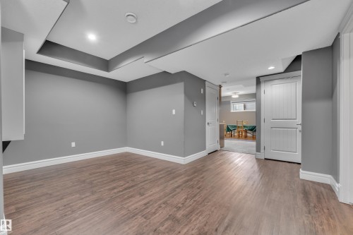 Basement with dark wood-type flooring and recessed lighting - 2612 Adam Court Sw, Edmonton, AB - Indoor Photo Showing Other Room