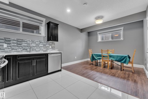 Dining space with light tile patterned floors and a textured ceiling - 2612 Adam Court Sw, Edmonton, AB - Indoor