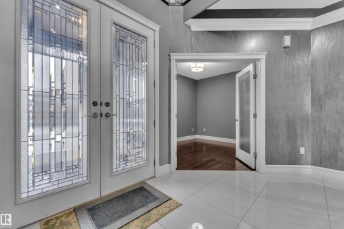 Tiled entrance foyer with french doors and baseboards - 2612 Adam Court Sw, Edmonton, AB - Indoor Photo Showing Other Room